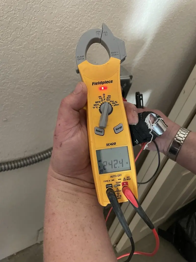 Voltage testing with clamp meter during Outlet Installation in Newark